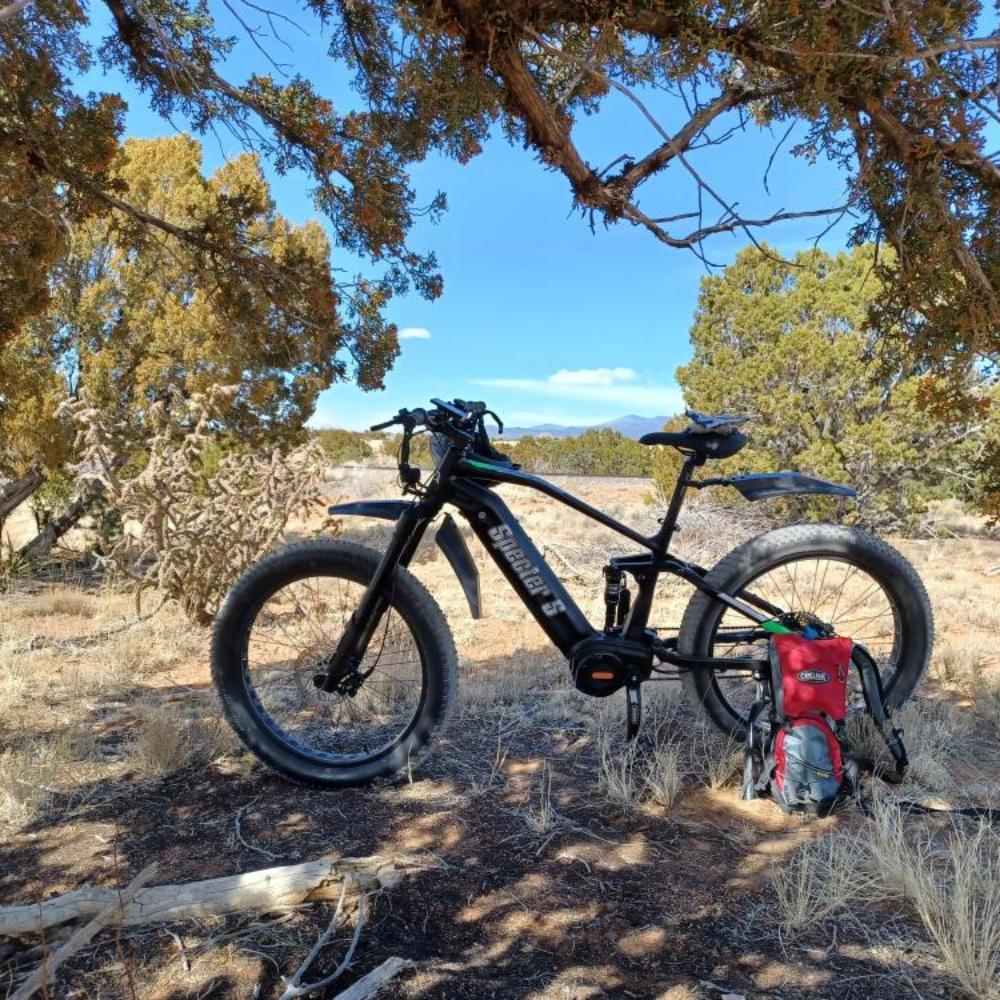 Life style image for the Specter-S Fat Tire Electric Mountain Bike by Eunorau - High-performance off-road full suspension eBike with Bafang Ultra Mid-Drive Motor, dual battery option, advanced suspension, and rugged 26” fat tires, designed for hunters, adventurers, and trail enthusiasts.