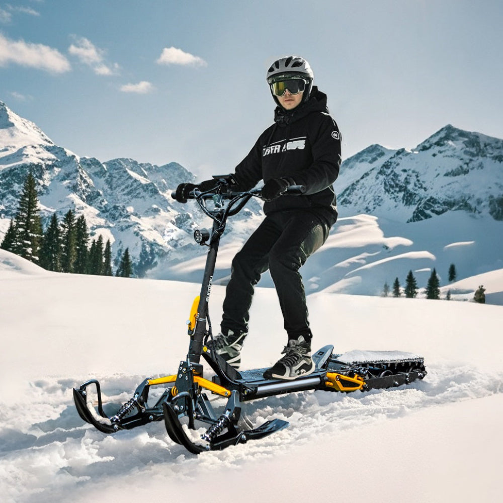 Person on a eSled snow bike in a snowy mountain landscape